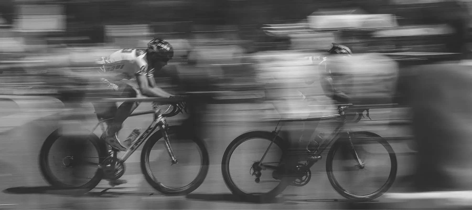 Family offices and venture capital firms, cyclists blurred at speed in a race.