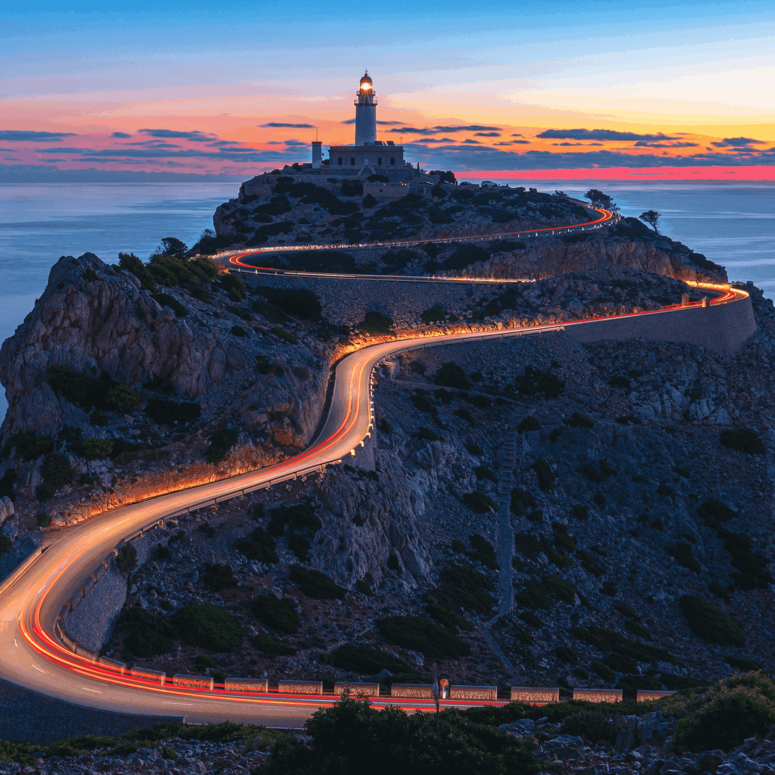 Winding coastal road leading to a lighthouse at sunset, symbolising direction and guidance for family offices