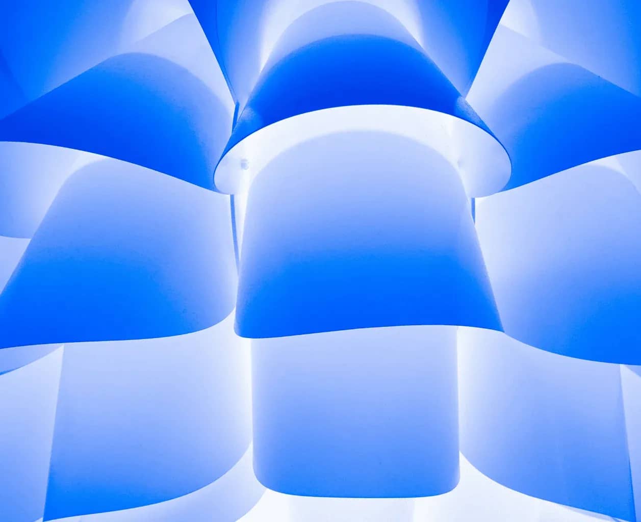 Family office investment reporting, folded planes of blue and white light forming soft geometric curves.