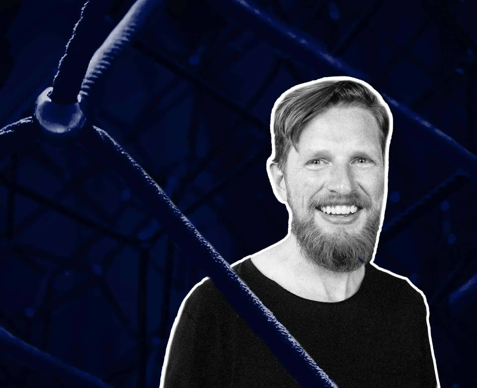 Matt Mullenweg net worth, a monochrome portrait of the WordPress founder laughing against a dark blue background.