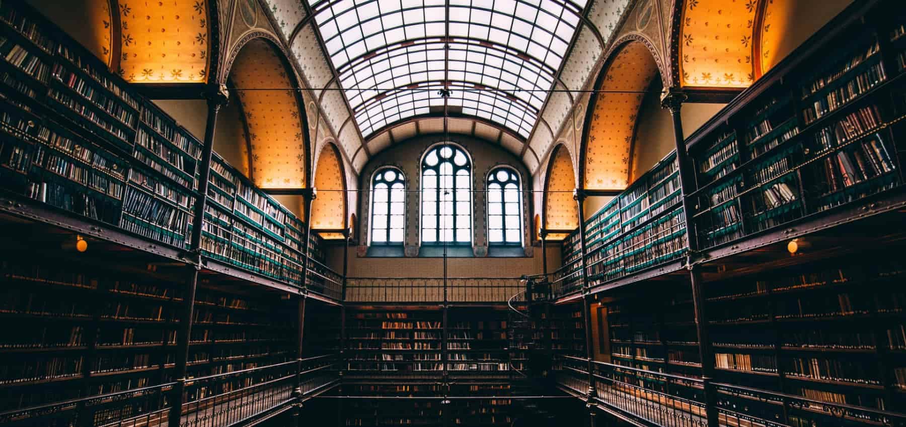 Fiduciary holding structures, a vaulted library of tall bookshelves and arched windows.