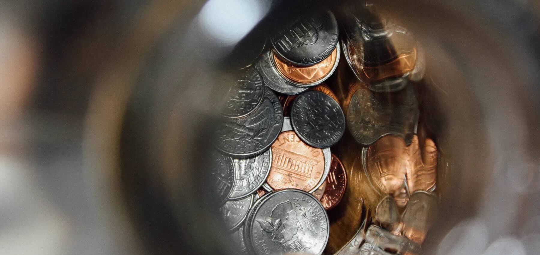 Cryptocurrency in family office portfolios, a heap of coins in warm close-up.