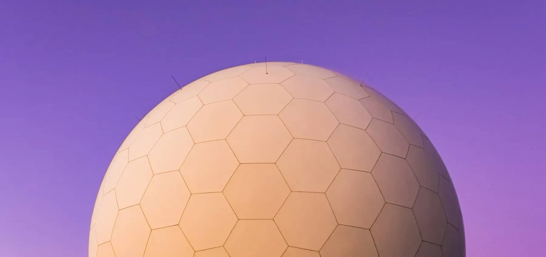 Real estate digital transformation, a large hexagon-panelled sphere against purple.
