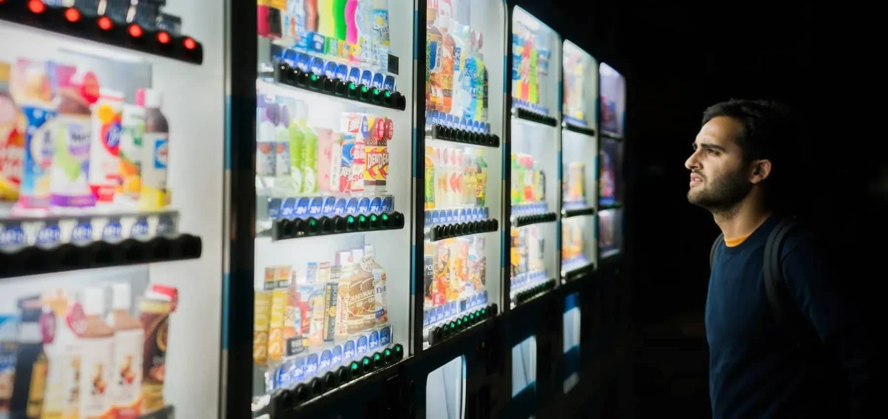 Family office asset classes, a person looking across brightly stocked shelves.