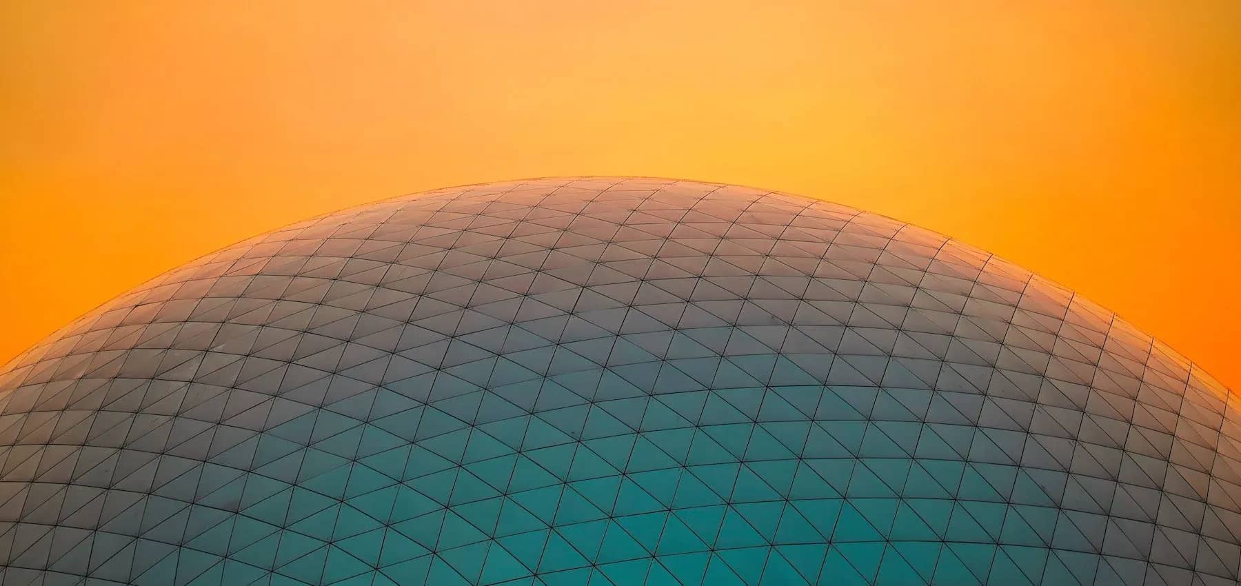 Protecting real estate assets, a large geodesic dome silhouetted against an orange sky.