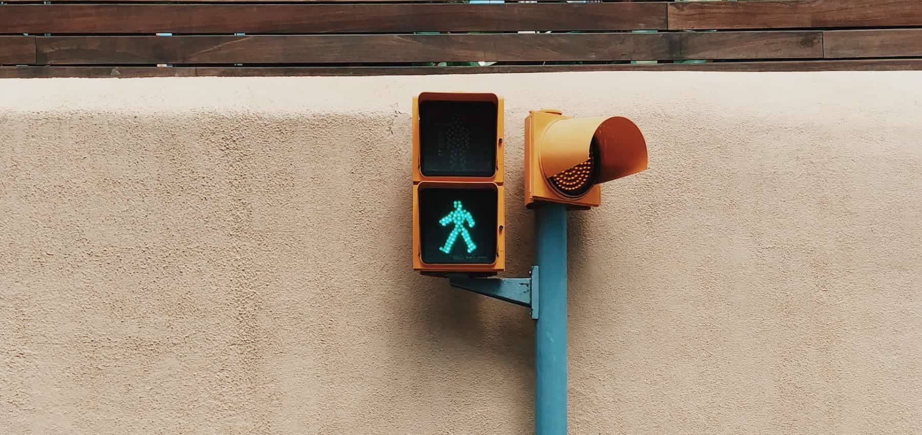 Family office regulation, a green pedestrian signal glowing on a beige wall.