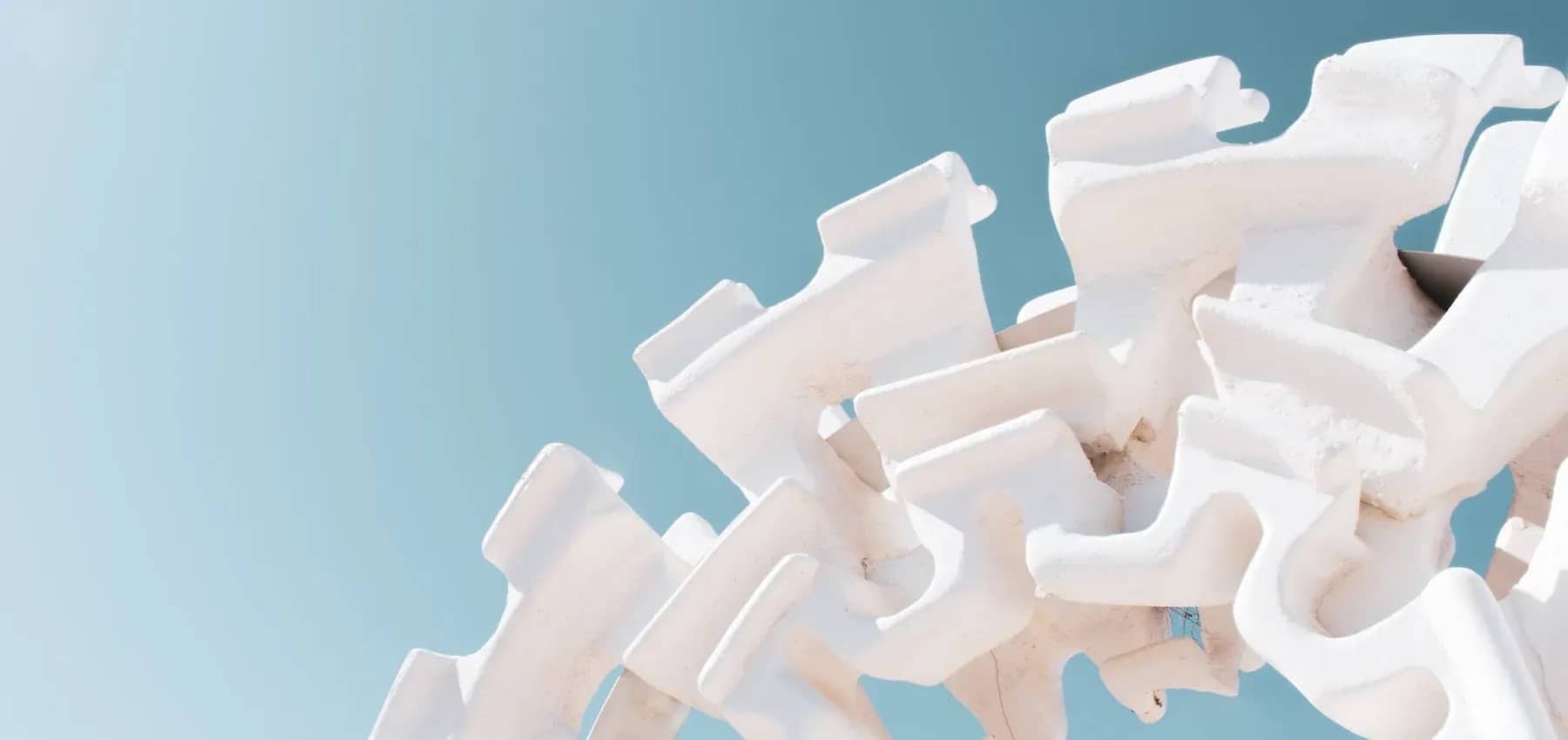 Family office services, a heap of white interlocking concrete tetrapods against the sky.