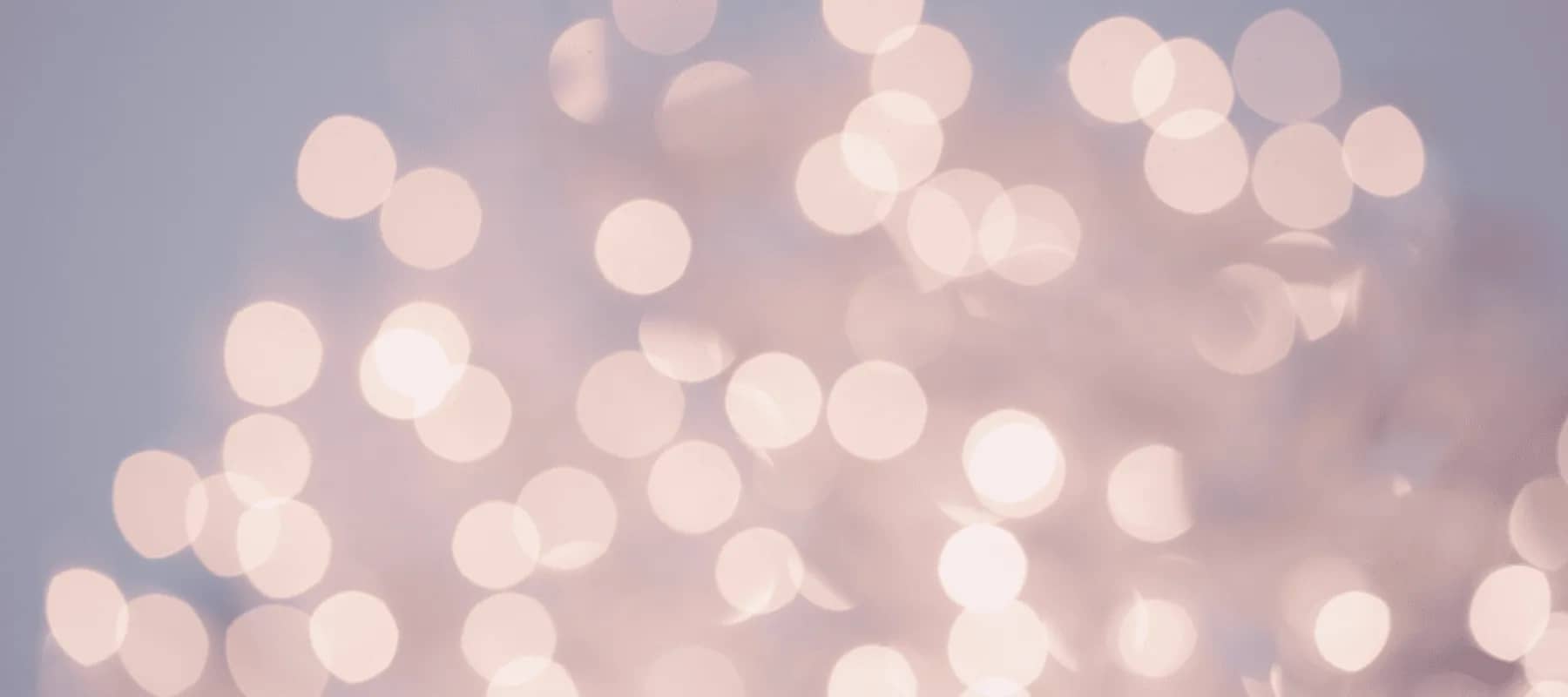 Philanthropic capital and donor advised funds, soft golden bokeh lights against a pink haze.