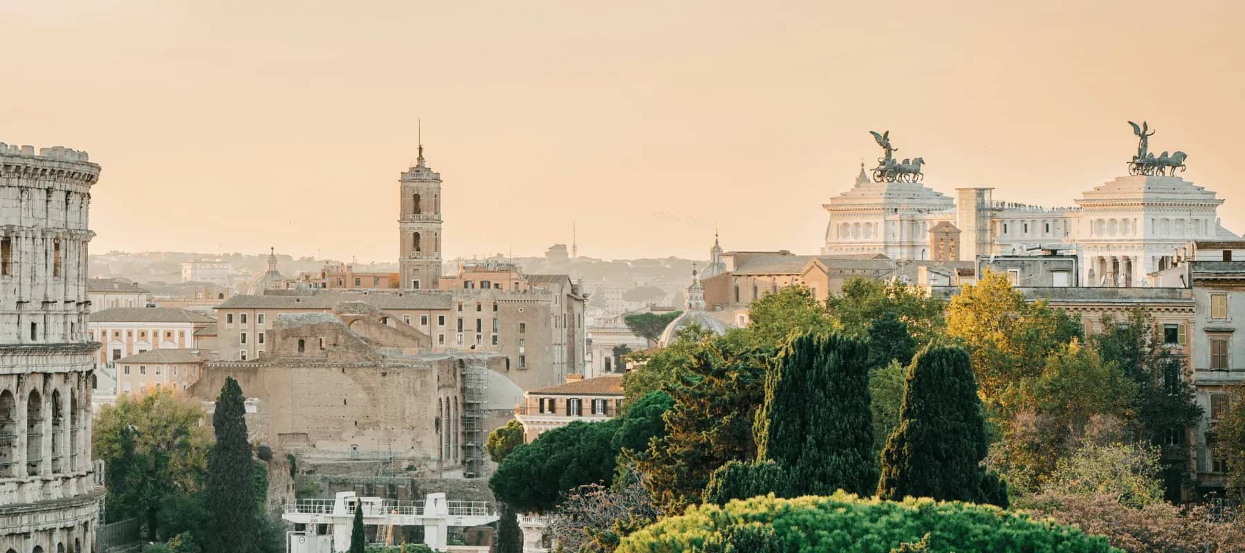 Italy as a destination for UHNWIs, the rooftops and domes of Rome at golden hour.