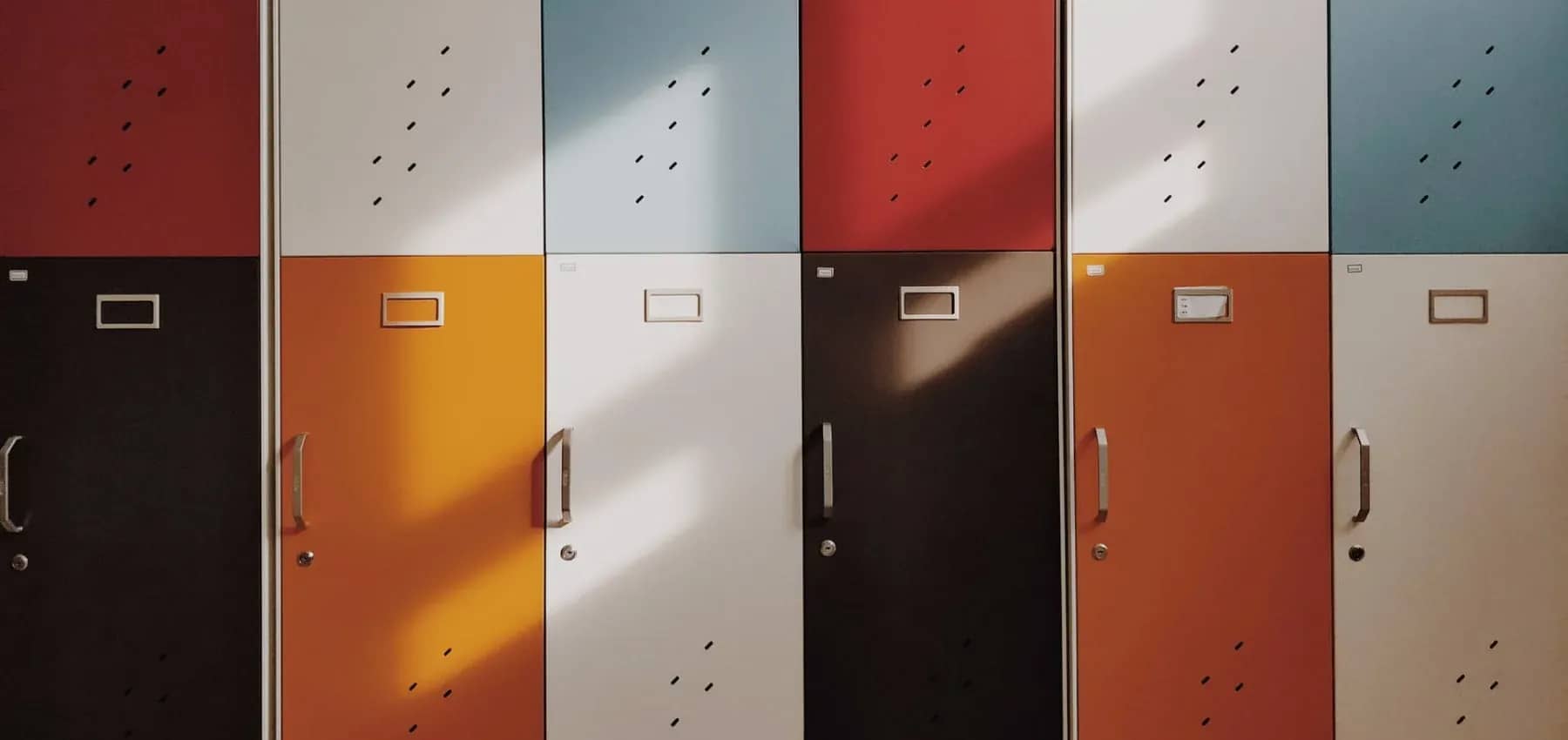 Investing in education, a row of lockers in muted colours.