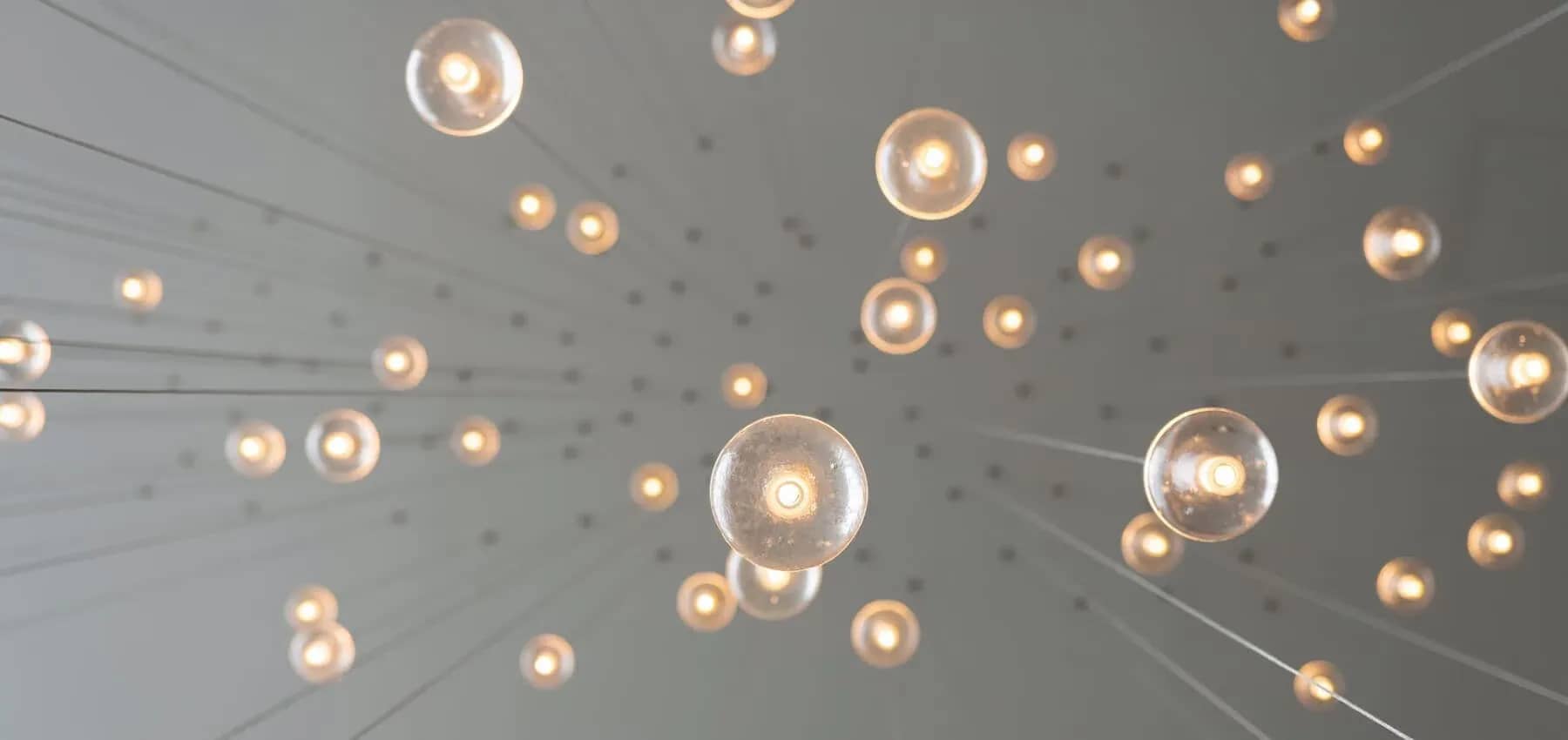 Mental health in family business, filament bulbs glowing on suspended wires.