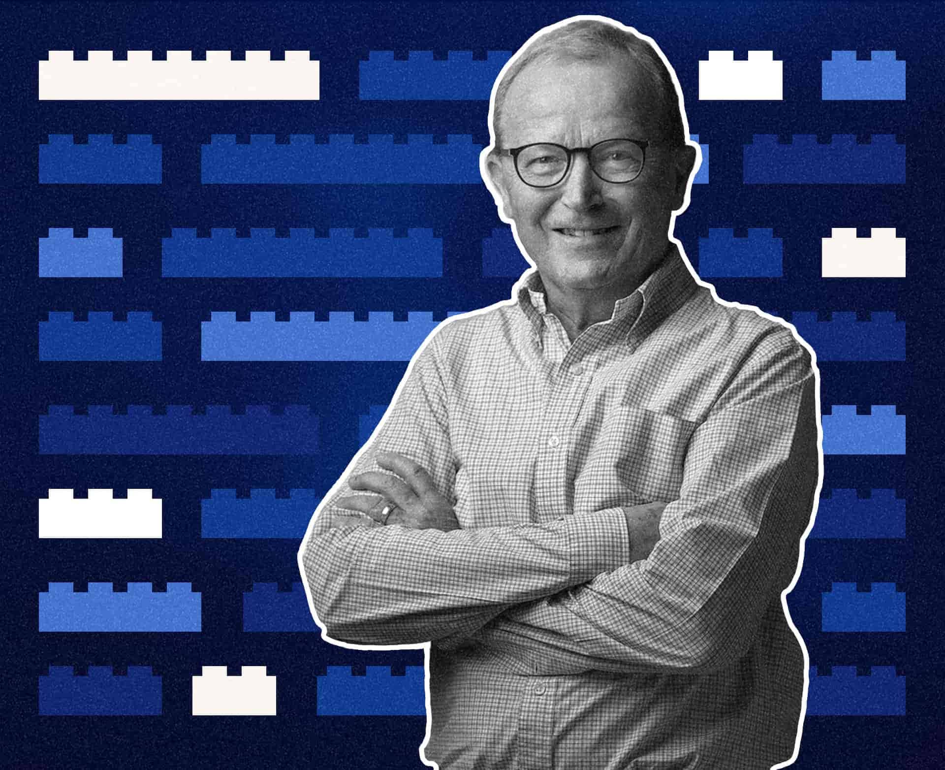 KIRKBI family office, a monochrome portrait of a man with folded arms against a pattern of blue LEGO bricks.