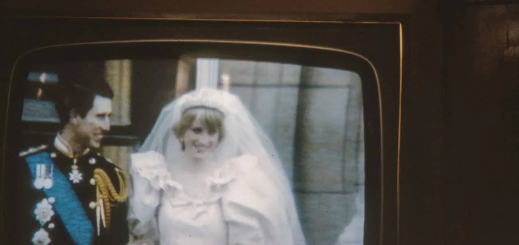 Family business conflict, a vintage television showing a royal wedding broadcast.