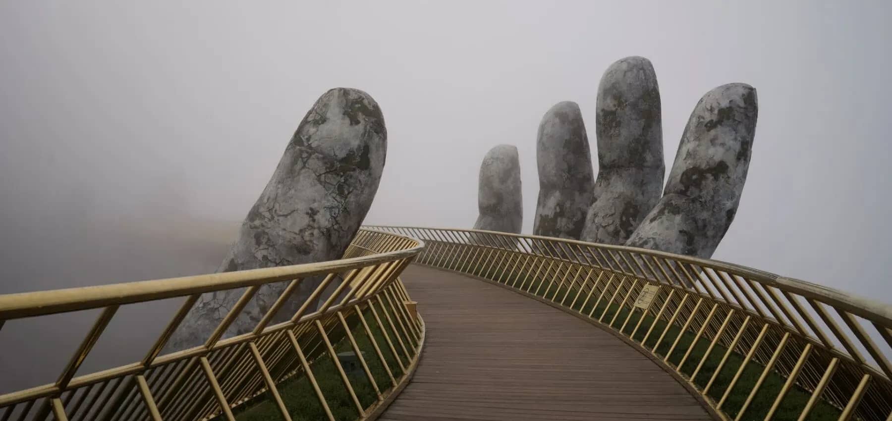 Family office wealth planning, a curved footbridge held aloft by giant stone hands in mist.