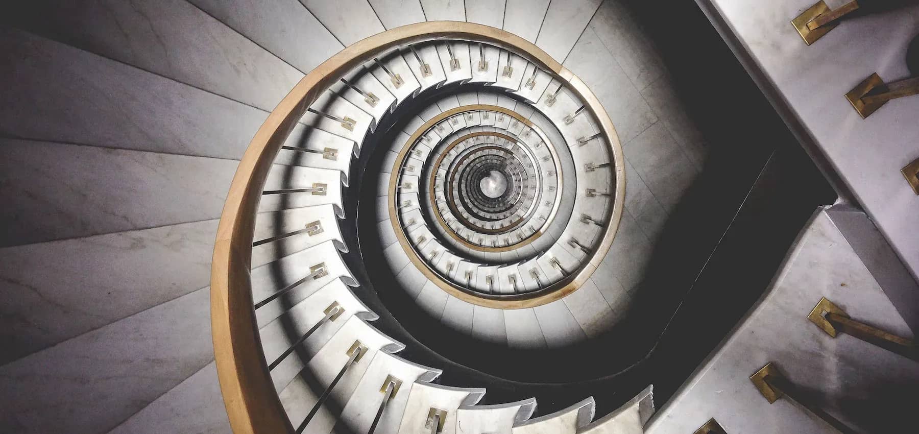 Multigenerational wealth preservation, a spiral staircase photographed from directly above.