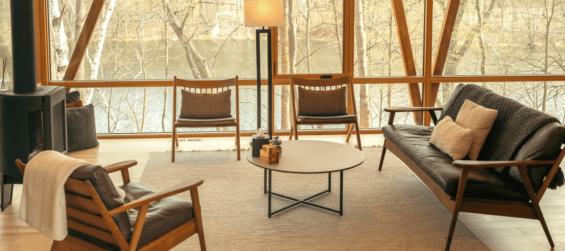 Luxury home living area with a view of trees and water, used to illustrate family office household management.