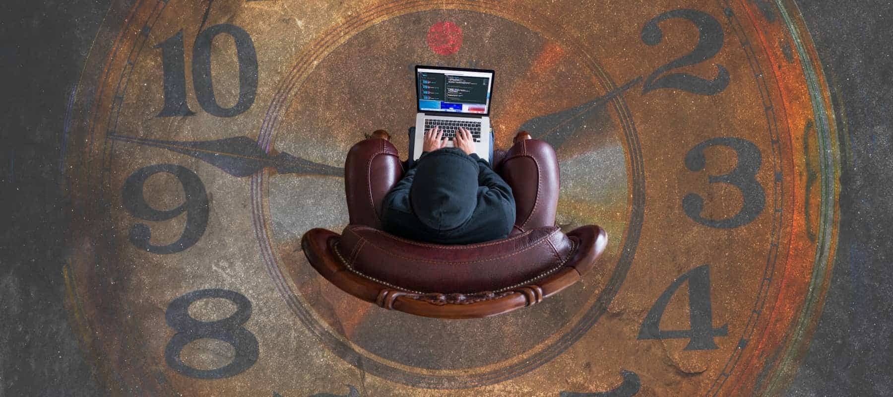 Venture due diligence, a person working on a laptop in a leather armchair set on a giant clock face.