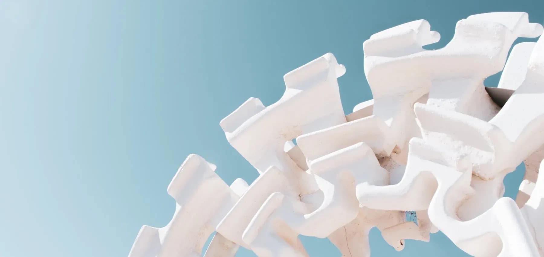 Family office services, a heap of white interlocking concrete tetrapods against the sky.