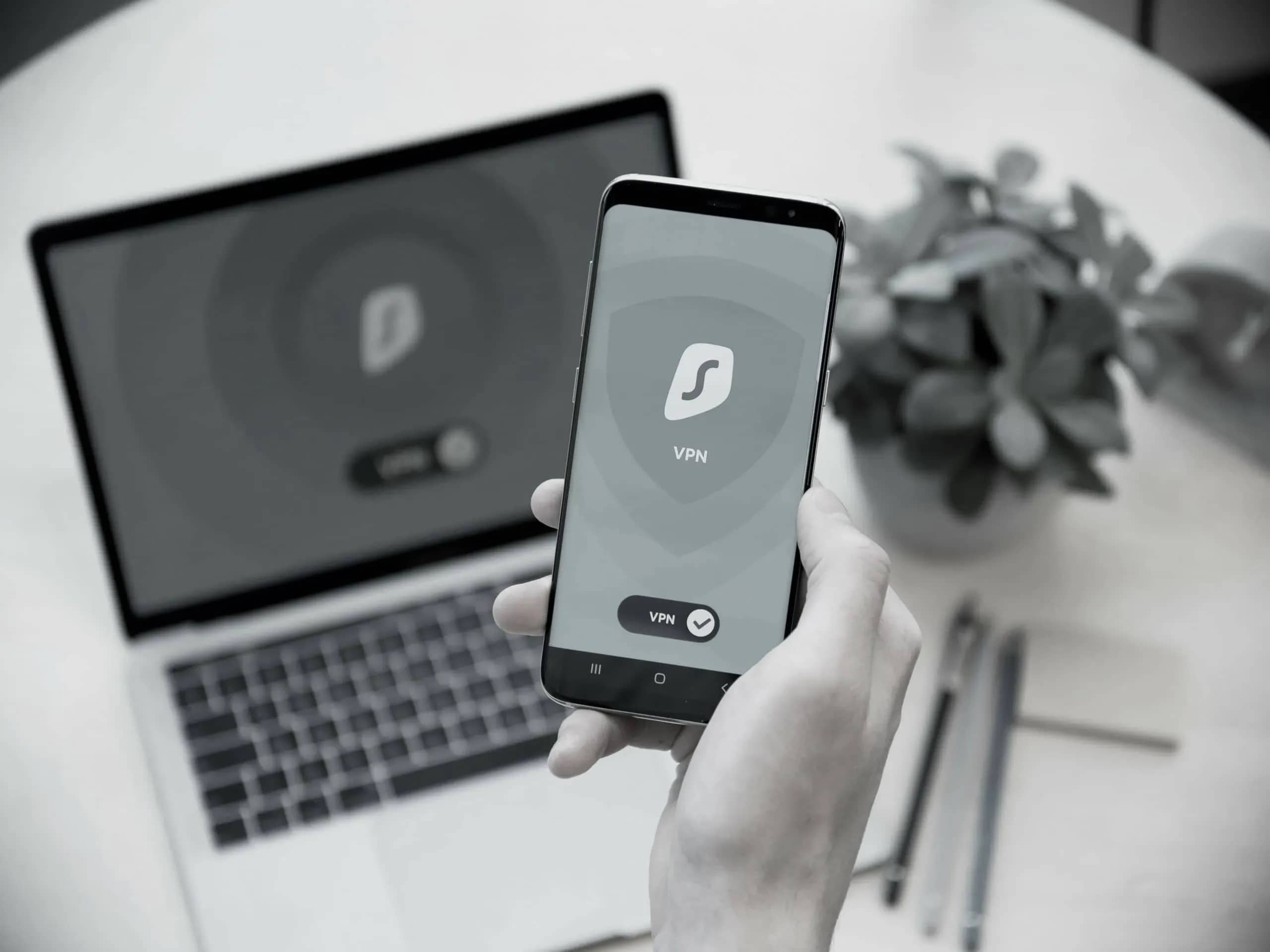 Family office cybersecurity, a hand holding a phone showing a VPN application.