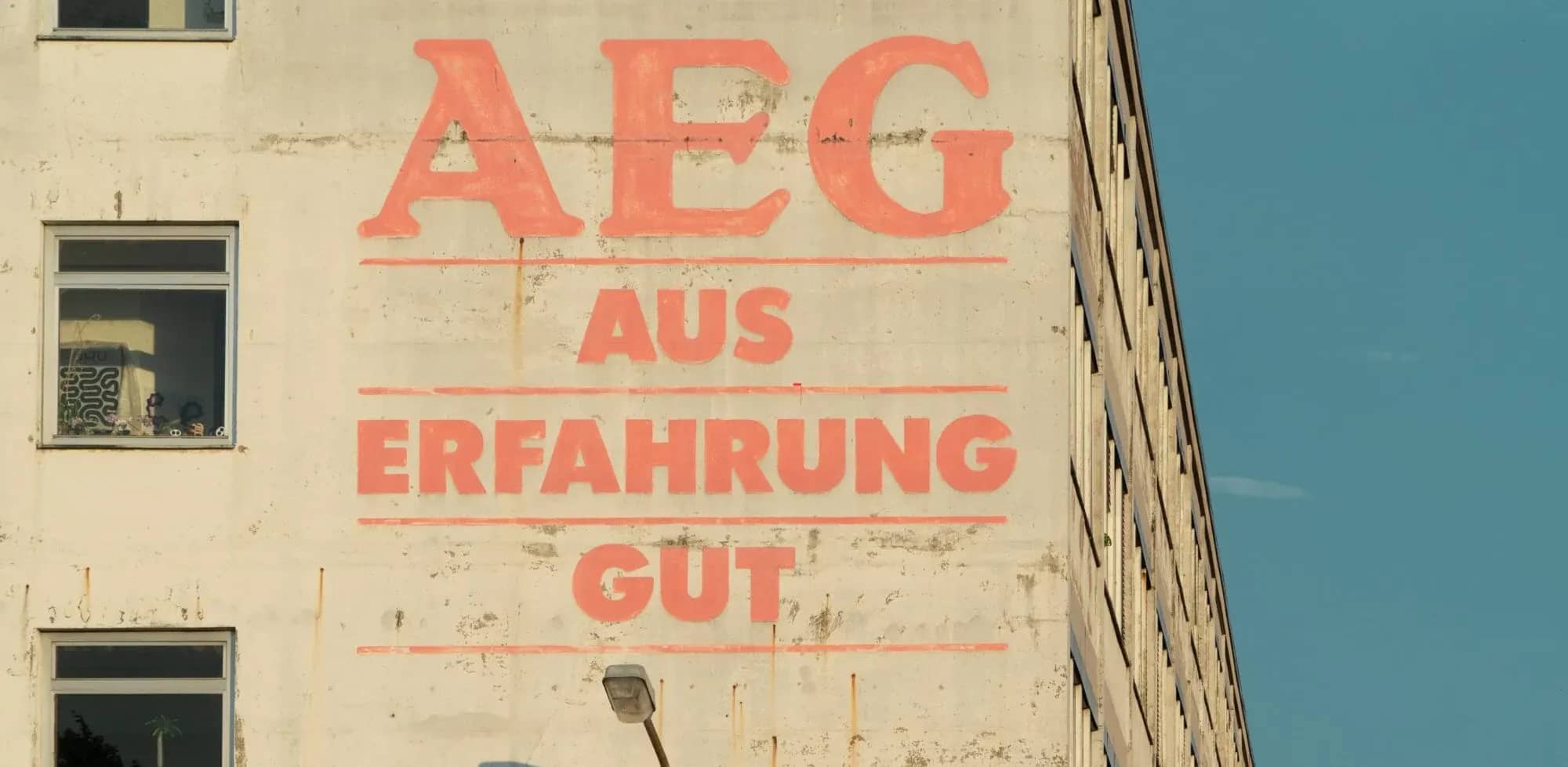 German family offices, a weathered wall painted with large red German lettering.