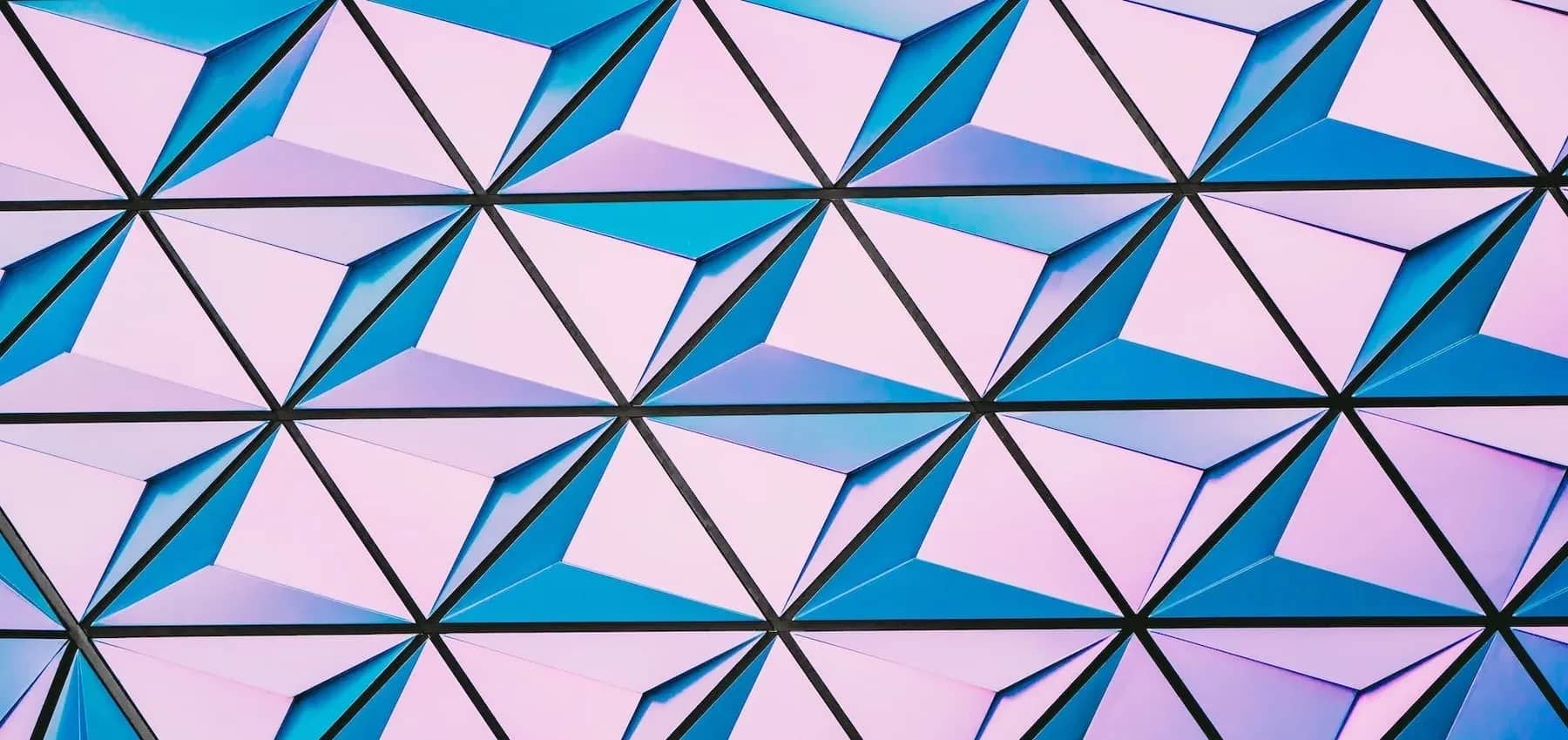 AI in family offices, a triangulated glass facade reflecting pink and blue.