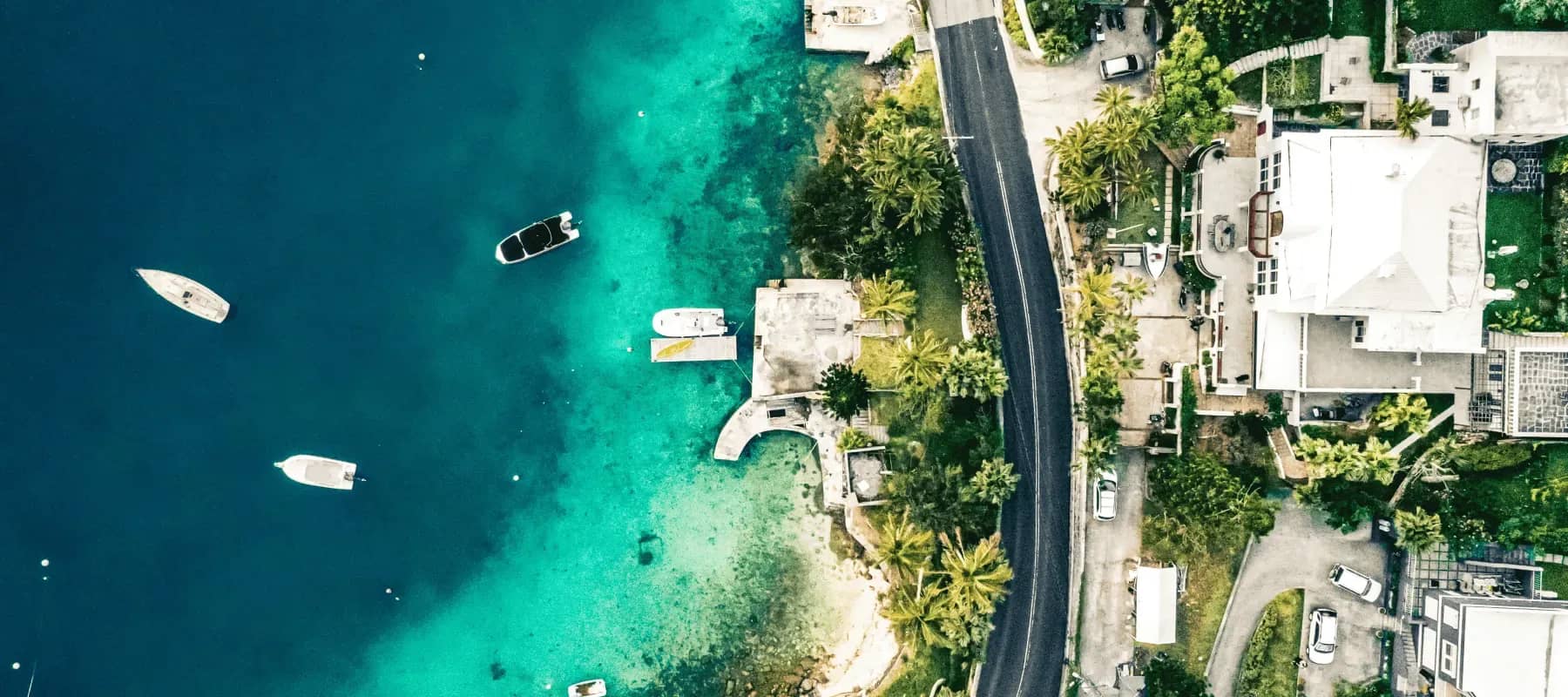 Bermuda privacy and asset protection, an aerial view of turquoise water, boats and waterfront homes.