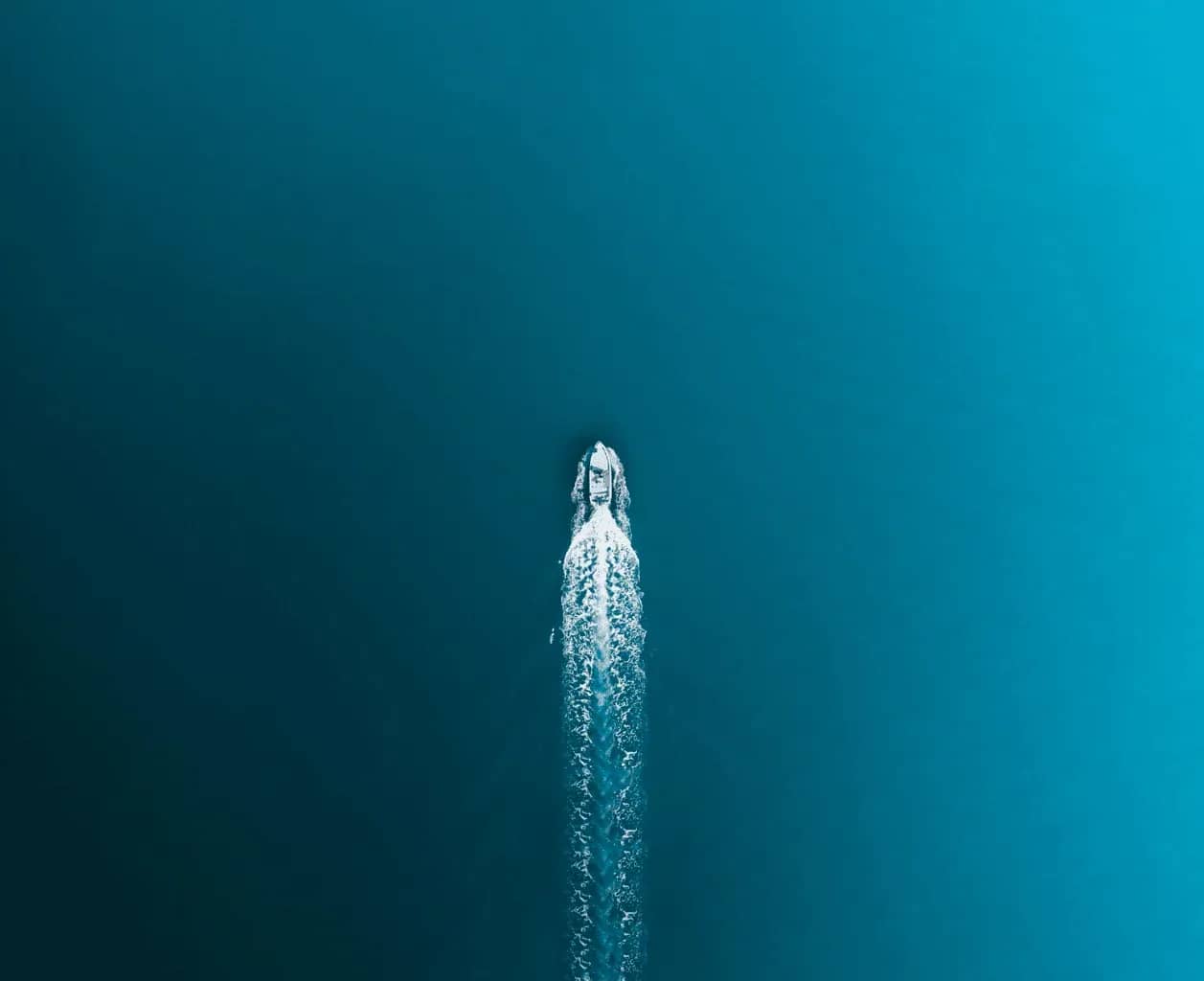 Investment operations reporting, a small illuminated column of falling water against a deep teal background.