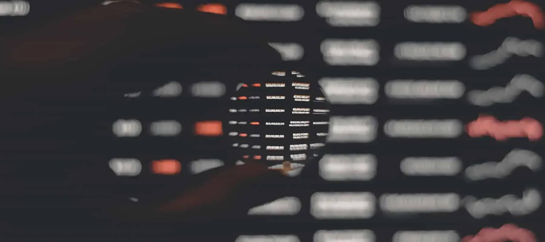 Family office digital security, a keyboard blurred in low light with orange highlights.