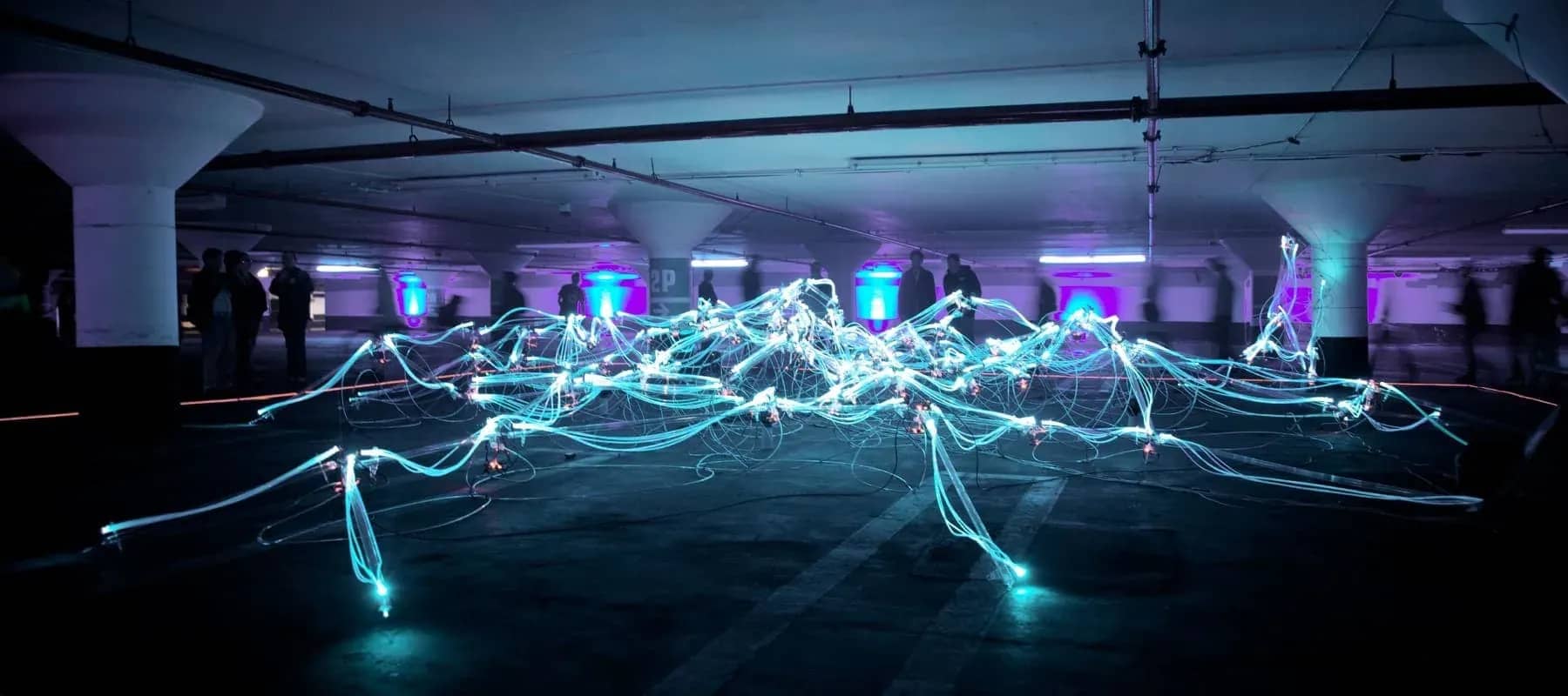 Digital asset banking, blue light trails streaking through a dark interior.