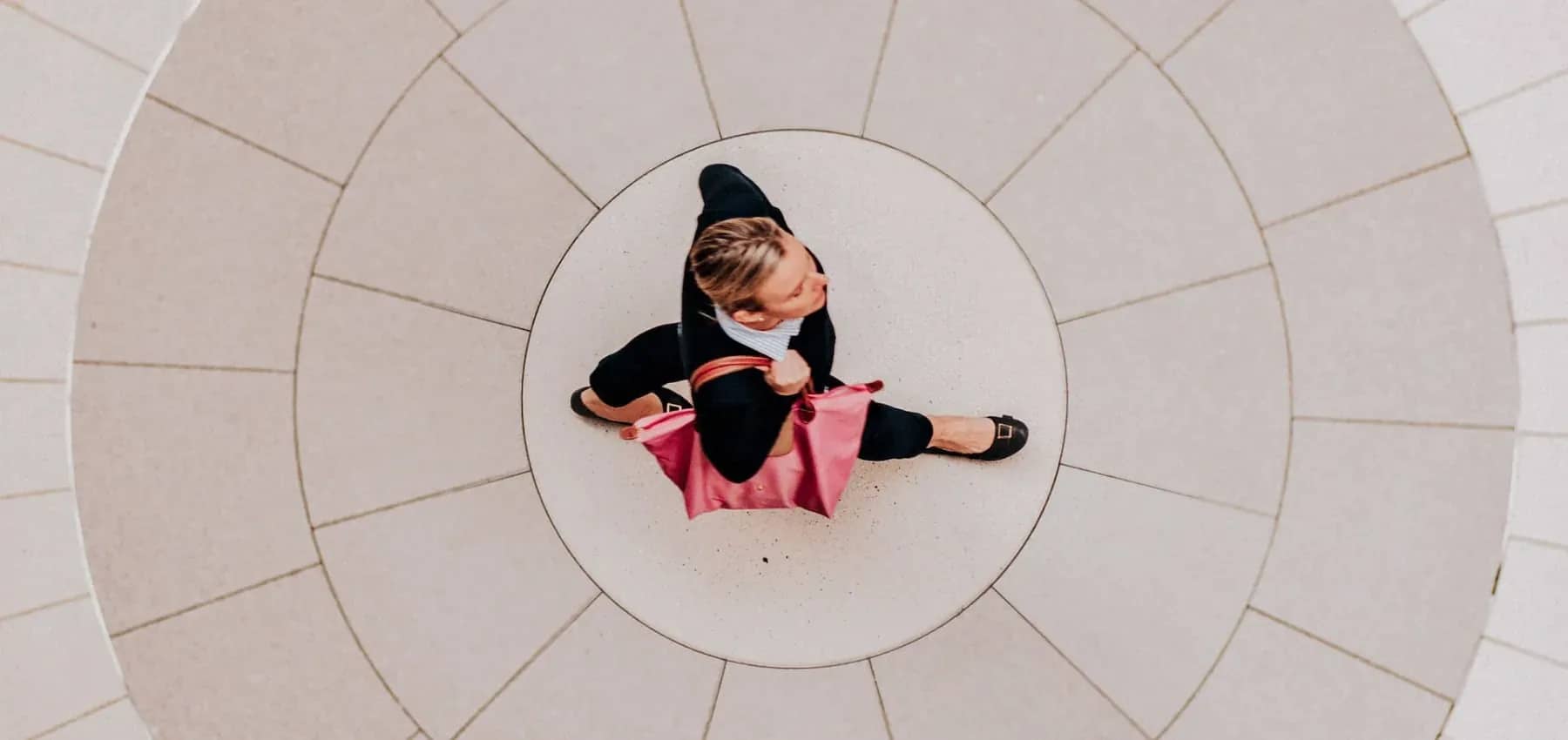 Family office advisory, a person sitting cross-legged at the centre of a circular paved pattern.