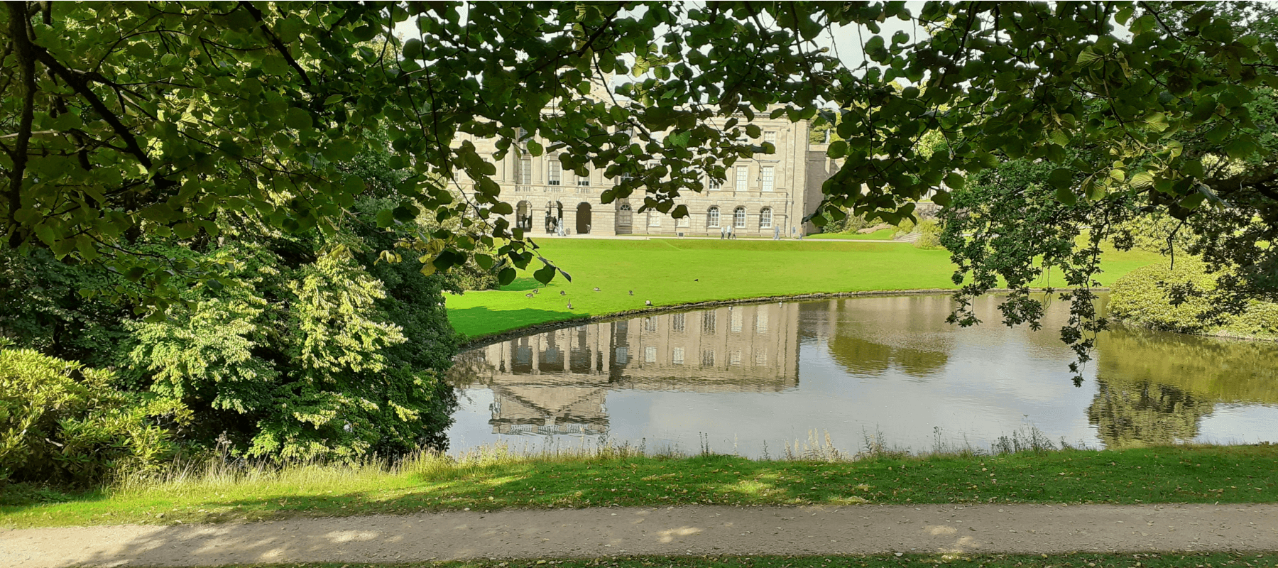 Family trusts explained, a country estate reflected in a still lake.