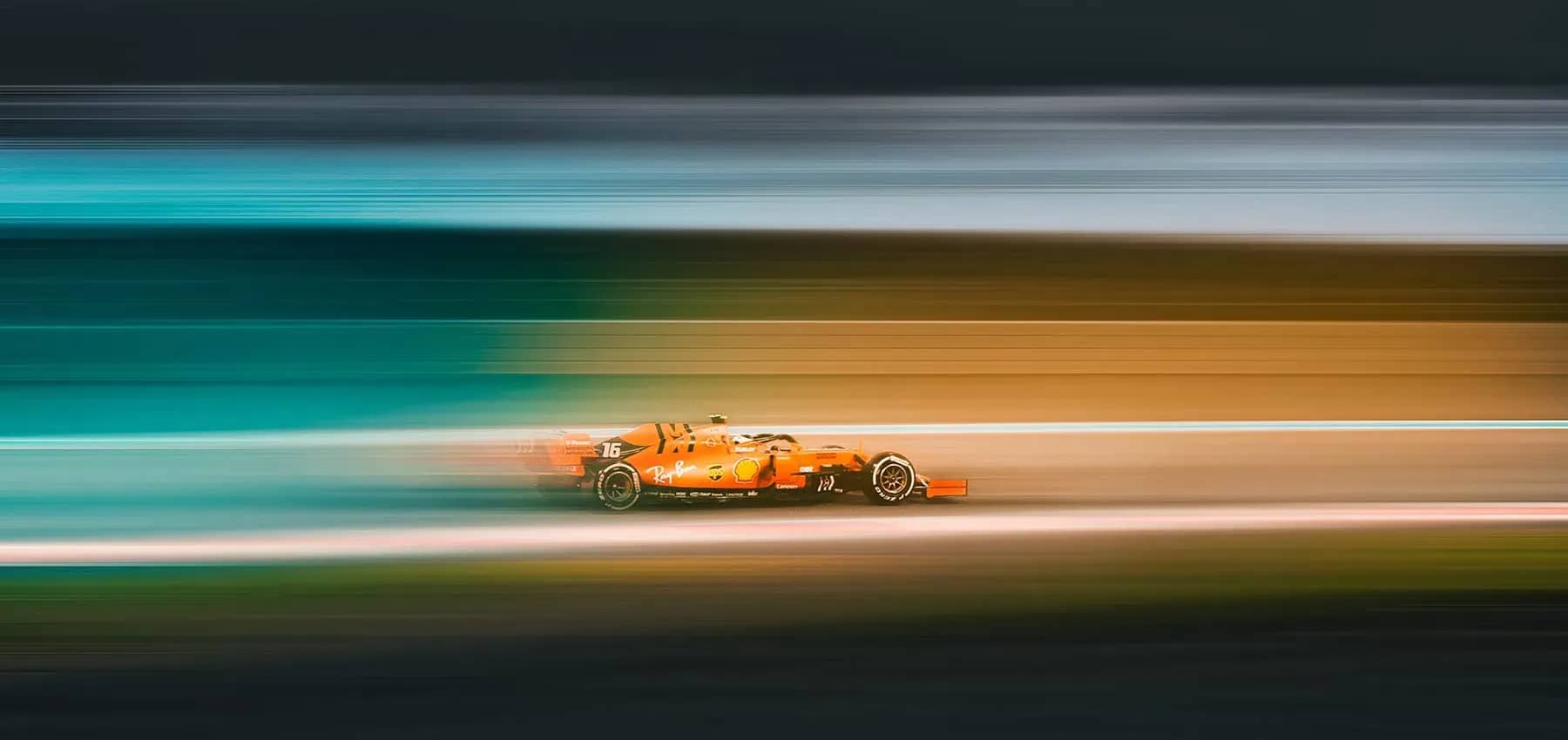 Investing in Africa, an orange racing car blurred at speed.