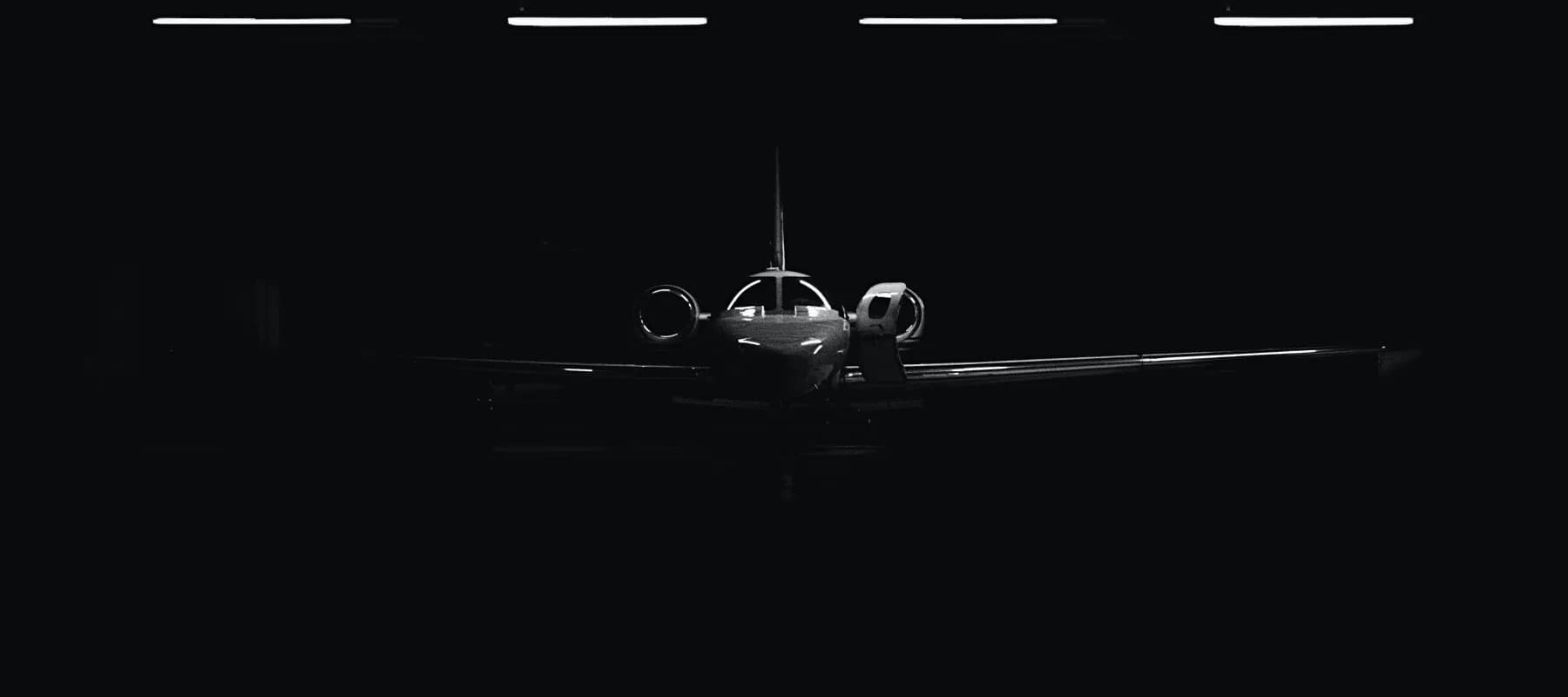 Lifestyle concierge services, a private jet resting in near darkness.