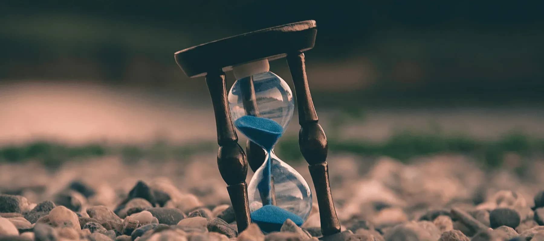Middle East family offices, an hourglass with blue sand against a green field.