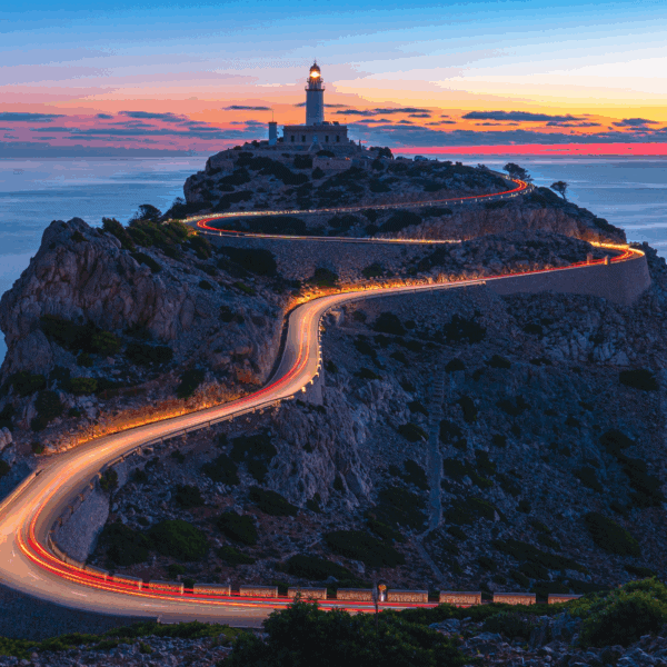 Winding coastal road leading to a lighthouse at sunset, symbolising direction and guidance for family offices