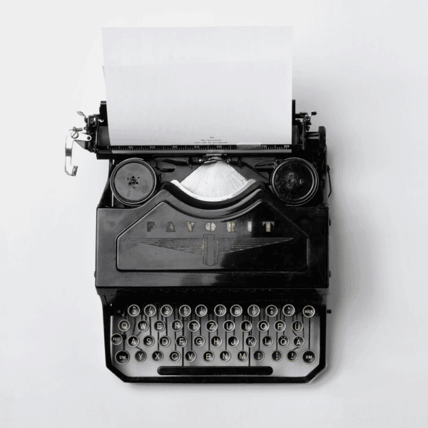 Vintage black typewriter with blank paper sheet, symbolising editorial and newsletter content Vintage black typewriter with blank paper sheet, symbolising editorial and newsletter content