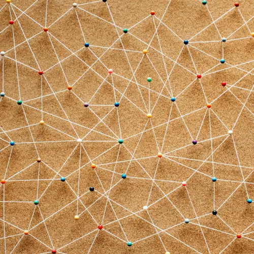 Network of coloured pins connected by white strings symbolising integration and automation in family office systems