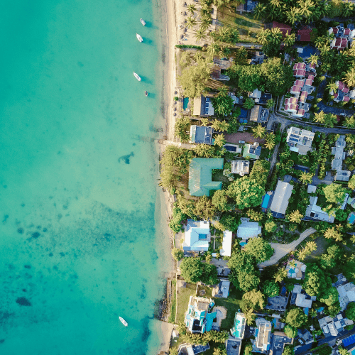 Aerial view of luxury homes along the Mauritius coastline, illustrating the island’s growing appeal as a hub for family offices and international wealth management.